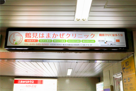 看板の下に階段があるので、その階段を下りて、JR鶴見駅西口から出て下さい。